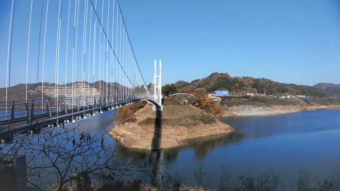 용두교에서 용의 등허리가 한눈에 보인다. 왼쪽의 흰 산이 철도용 자갈을 캐던 산, 오른쪽에 점점이 보이는 주황색 지붕이 새로운 금강마을이다.