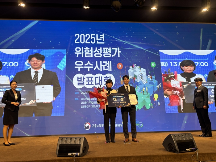 지난 25일 고용노동부·안전보건공단 공동주최 위험성평가 우수사례 발표대회에서 제조업 대기업 분야 대상을 받은 아진산업 최인열 이사(안전보건관리책임자·오른쪽)가 고용노동부 관계자와 함께 기념촬영을 하고 있다. <아진산업 제공>