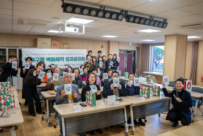 벽화 제작 성과공유회에 참석한 지역 주민, 청년, 창작자들이 기념촬영을 하고 있다.