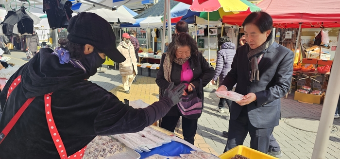 4일 이승익 고령관광재단 대표가 고령전통시장에서 찹쌀떡을 구입하고 있다. <석현철 기자>