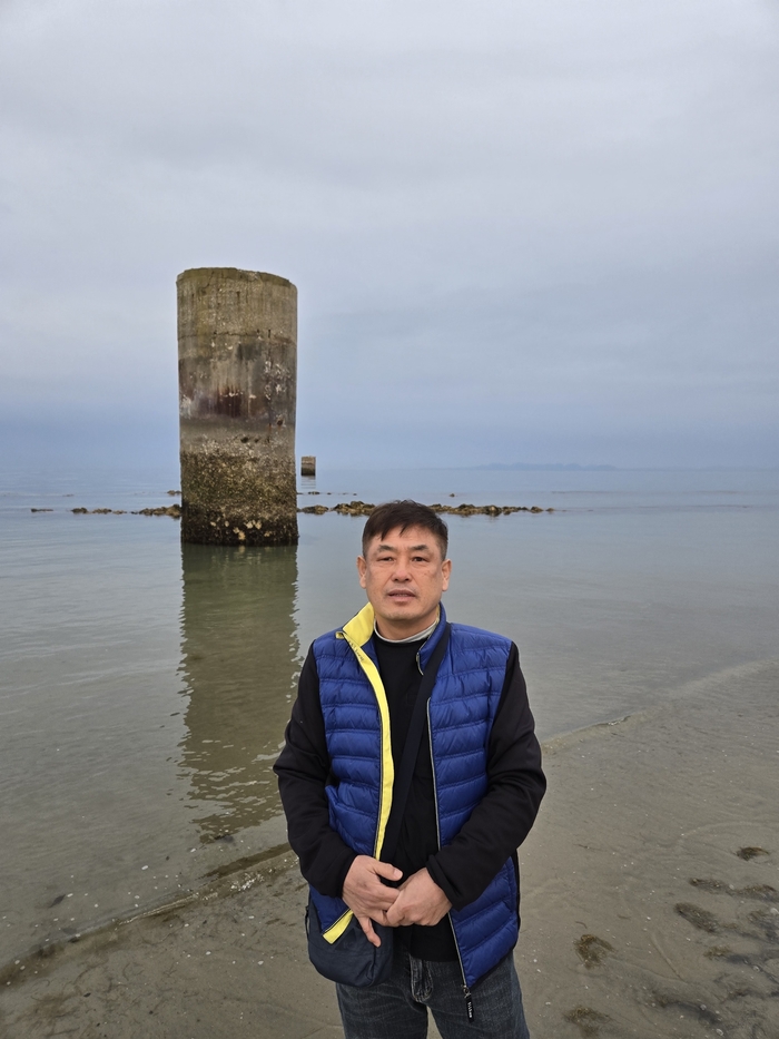 지난해 4월 일본 조세이탄광 유골 발굴조사 현장을 찾은 전영복씨가 탄광 배기구(피아)를 배경으로 촬영하고 있다. <전영복씨 제공>