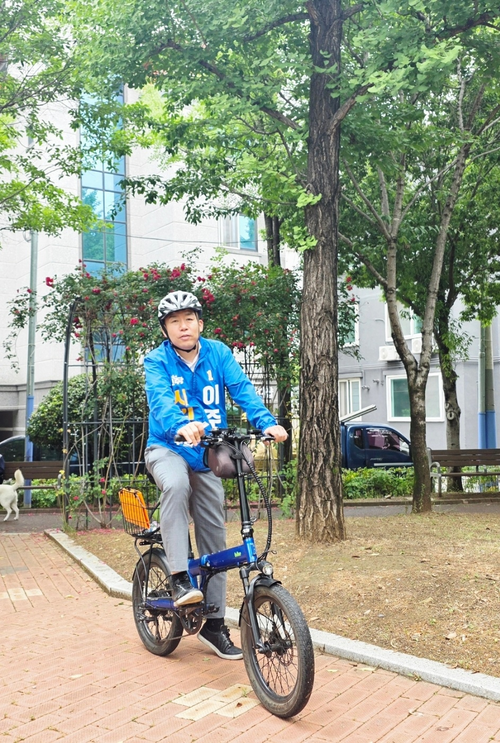 대구 서구 제1선거구에 출마한 더불어민주당 이주한 후보가 자전거를 타고 다니며 선거운동을 하고 있는 모습. <후보 제공>