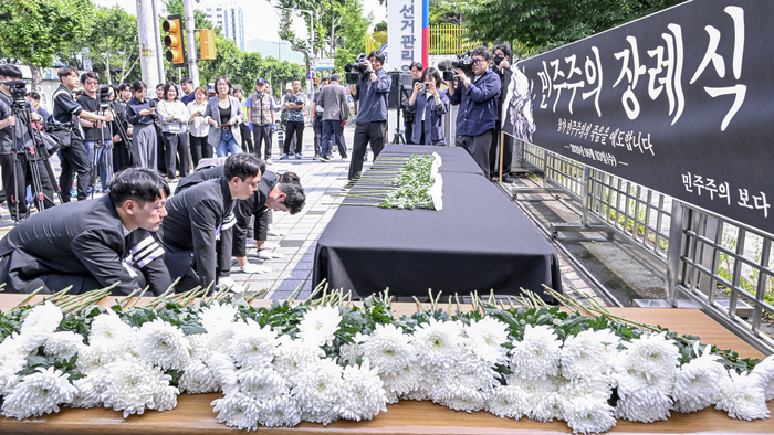 8일 오후 대구 서구 대구광역시선거관리위원회 앞에서 6·3 지방선거 출마자들과 시민들이 민주주의 장례식에서 국화를 헌화한 뒤 절을 하고 있다. 이날 행사에는 당선인과 낙선자들이 함께 참여해 선거 과정에서 발생한 참정권 침해와 선거 신뢰 훼손 문제를 제기했다.
이현덕기자 lhd@yeongnam.com